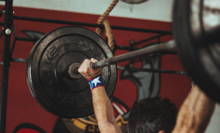 A man lifting a bar-bell weight