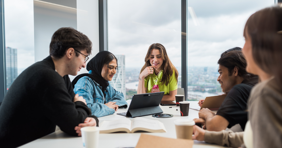 Two male students shake hands in a lecture